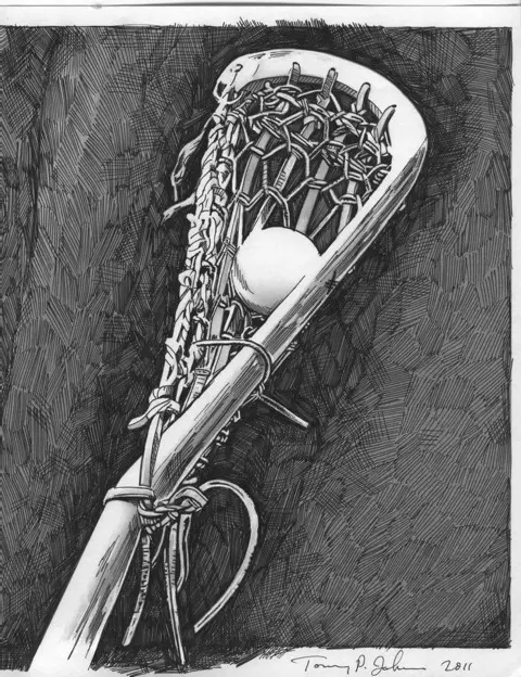 A lacrosse stick with a ball in it.